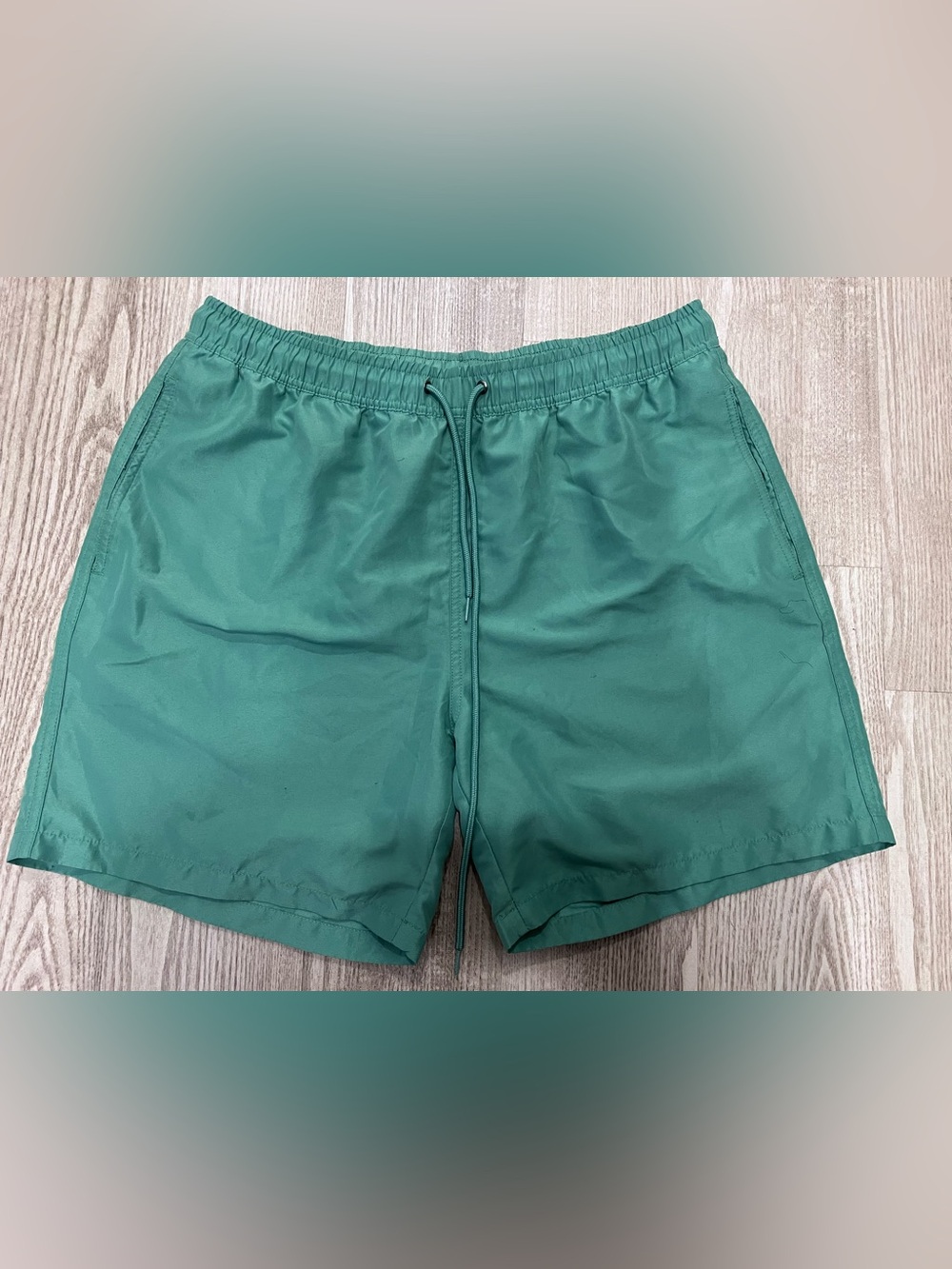 Men green swim trunks